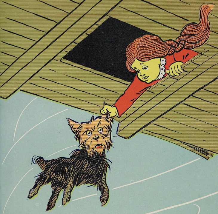 Dorothy holding Toto the dog by the ear while their house blows away